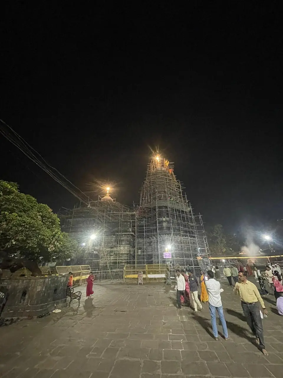 Night view of temple in Maharashtra with devotees visiting through Kadam Tours and Travels cab service